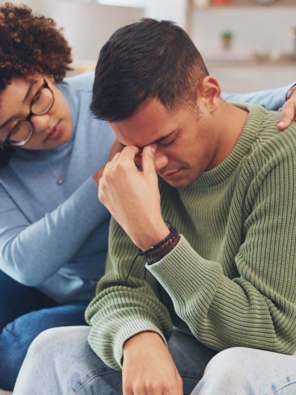 a woman comforting her male friend